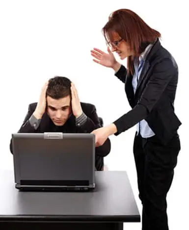 Angry businesswoman showing her emplyee the mistakes on a laptop