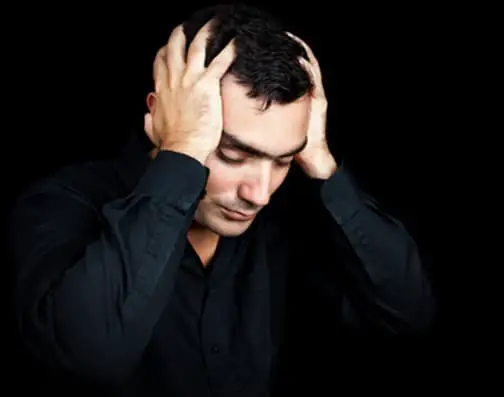 Hispanic man suffering a strong headache or depression