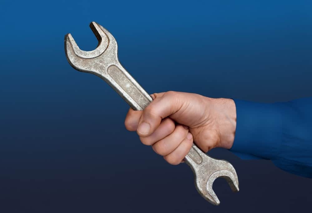 Male's hand with a wrench