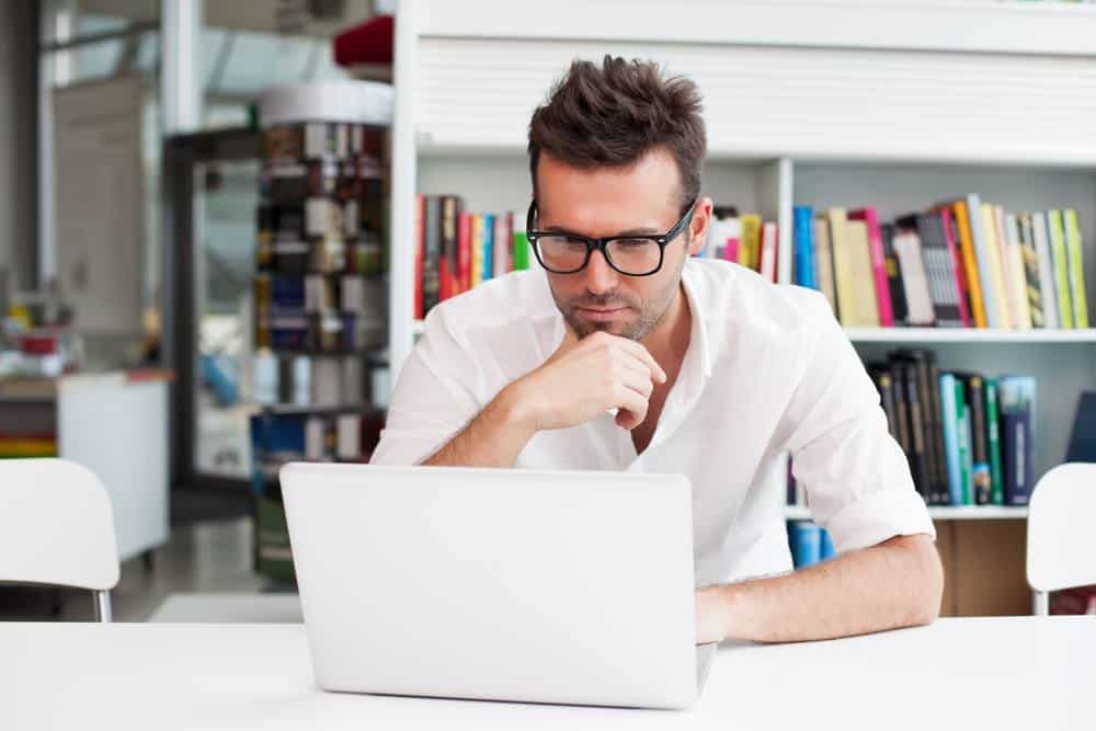 Happy man working with laptop