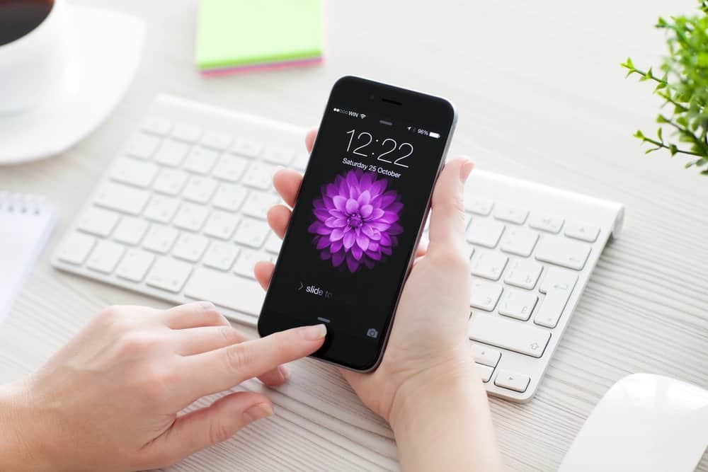 Woman unlock iPhone 6 Space Gray over the table