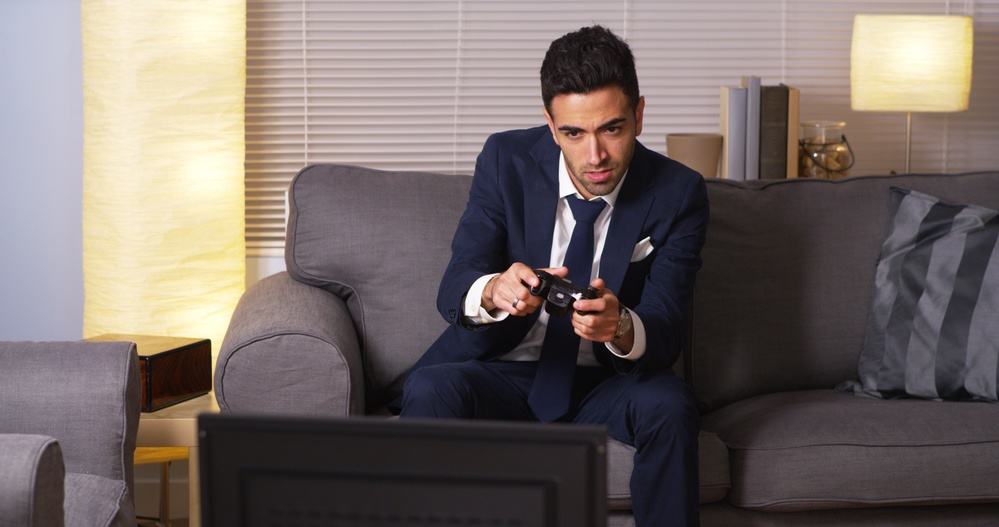 Mexican businessman playing video games at home