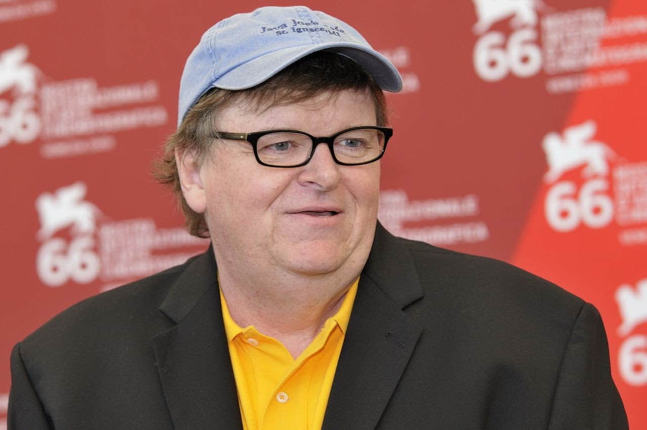 Documentarian and Activist Michael Moore in a baseball cap and glasses